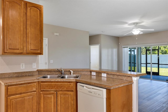 kitchen featuring ceiling fan, dishwasher, a peninsula, brown cabinetry, and a sink