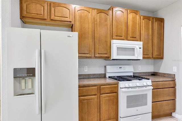 kitchen with white appliances and brown cabinets