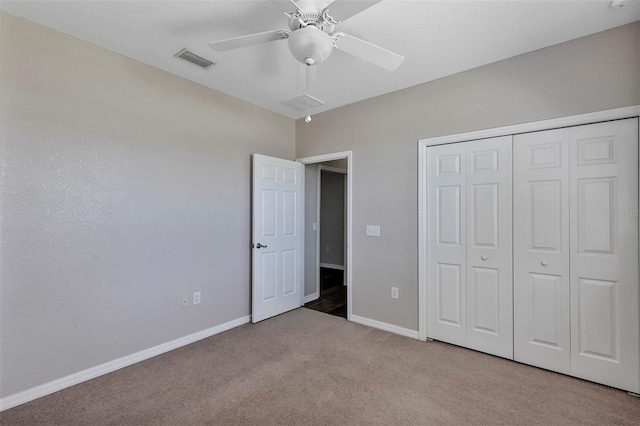 unfurnished bedroom featuring a ceiling fan, baseboards, visible vents, carpet floors, and a closet