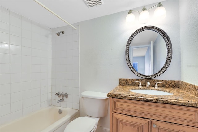 bathroom with visible vents, toilet, shower / washtub combination, and vanity