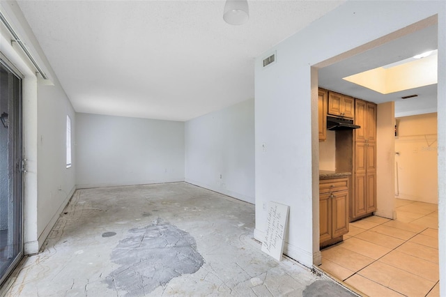 unfurnished living room featuring visible vents and baseboards