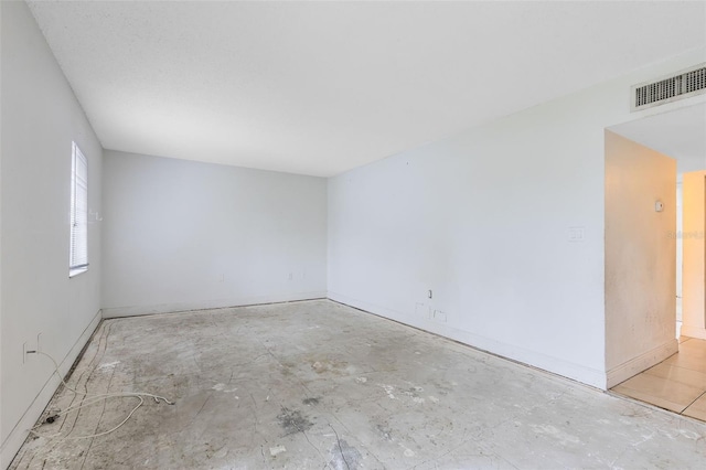 unfurnished room with visible vents and baseboards