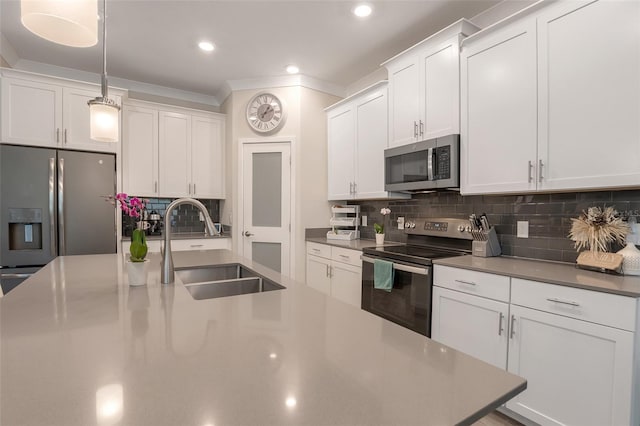 1472 Rushing Rapids Way, Winter Springs, FL 32708 - kitchen featuring stainless steel appliances, tasteful backsplash, white cabinets, decorative light fixtures, and recessed lighting