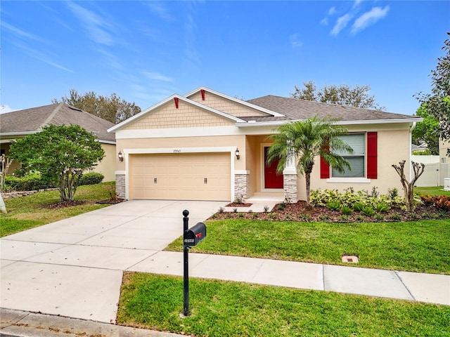 craftsman house featuring roof with shingles, stucco siding, a garage, driveway, and a front lawn