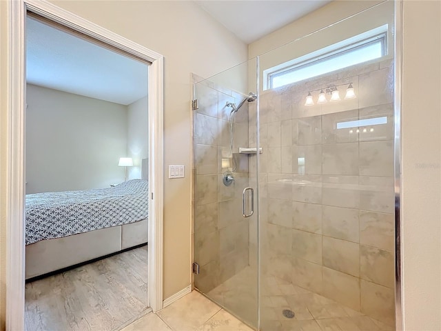 ensuite bathroom with a shower stall and connected bathroom