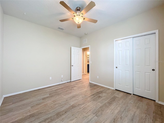 unfurnished bedroom featuring light wood-style flooring, visible vents, and baseboards