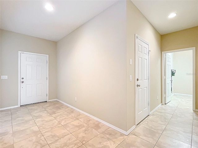 entryway with baseboards and recessed lighting