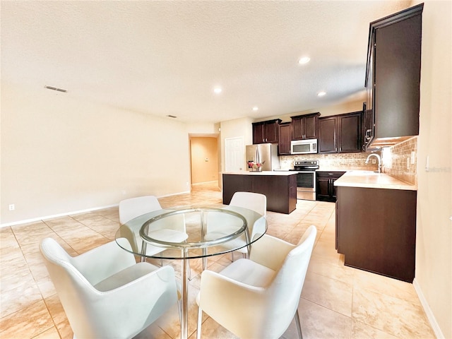 dining area with light tile patterned floors, recessed lighting, visible vents, and baseboards