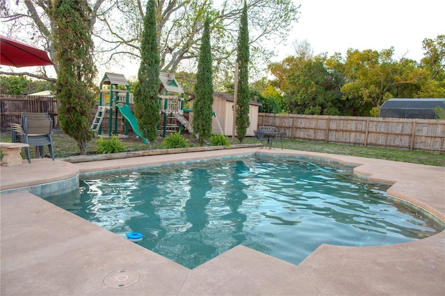 view of swimming pool featuring an outbuilding, a fenced backyard, and a fenced in pool