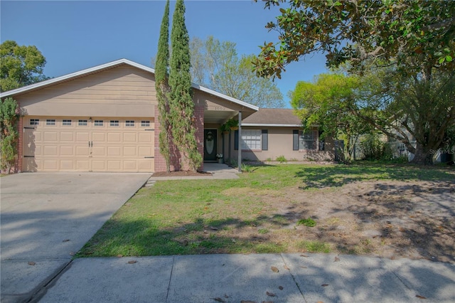 ranch-style house with an attached garage, concrete driveway, and a front yard