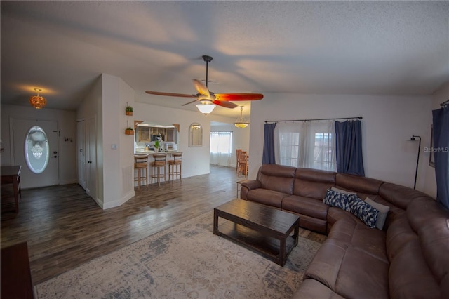 living room featuring a ceiling fan and wood finished floors