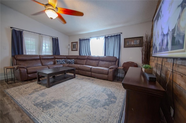 living room featuring ceiling fan, vaulted ceiling, and wood finished floors