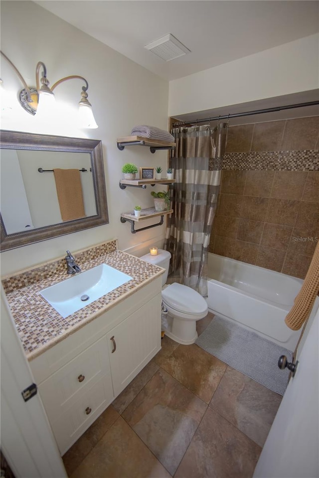 full bathroom featuring visible vents, shower / bath combo, vanity, and toilet