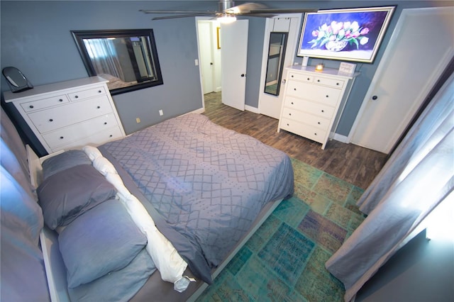 bedroom featuring ceiling fan and dark wood finished floors