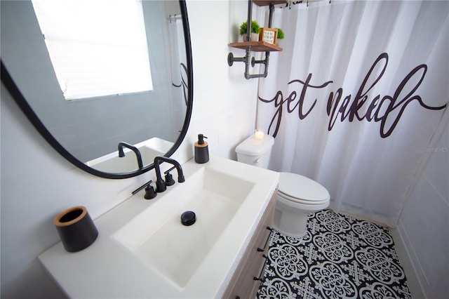 bathroom featuring curtained shower, vanity, toilet, and tile patterned floors