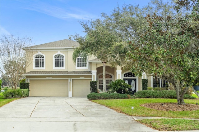 view of front of property featuring an attached garage, driveway, and stucco siding