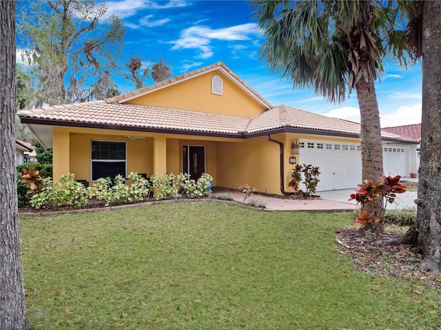 view of front facade with a front lawn, a tile roof, an attached garage, and stucco siding