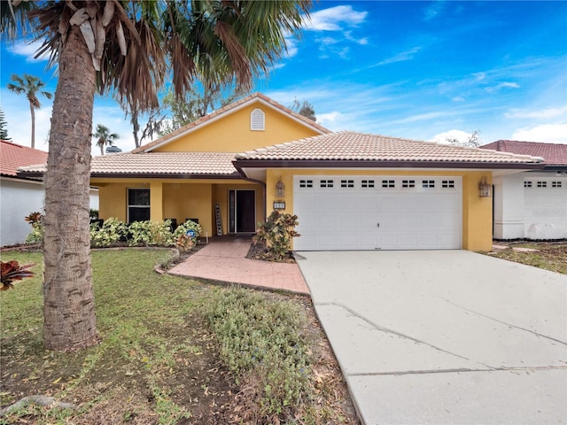 single story home featuring a garage, driveway, stucco siding, a tiled roof, and a front yard