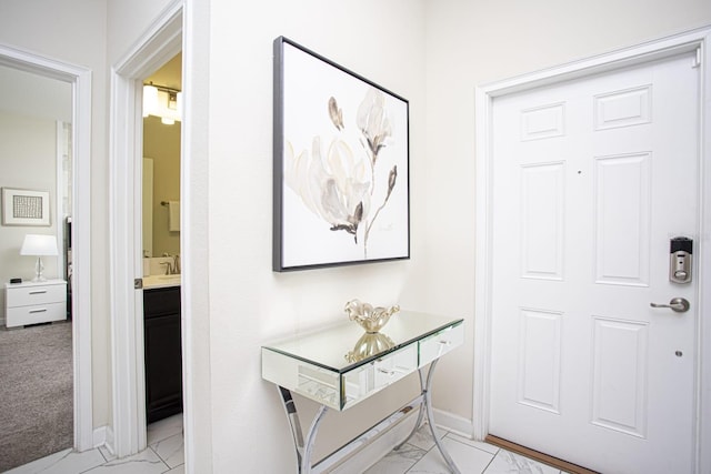 entryway featuring marble finish floor and baseboards