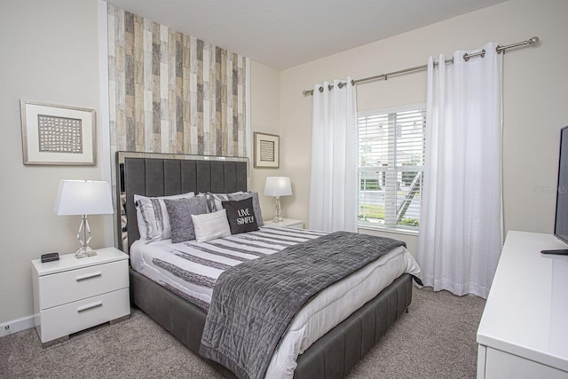 bedroom with light carpet and baseboards