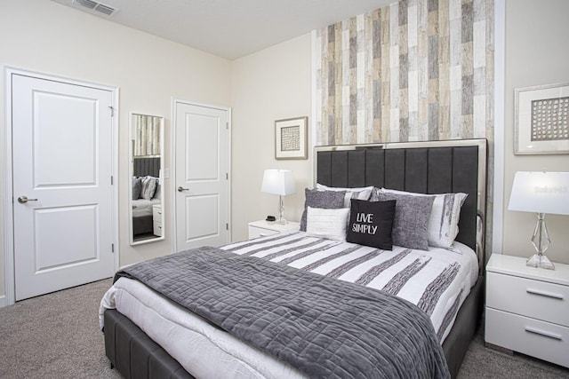 carpeted bedroom featuring visible vents