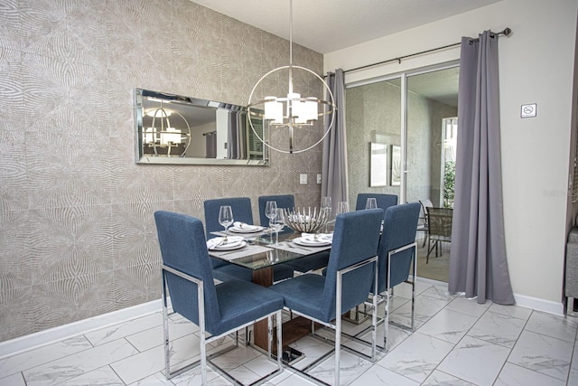dining room featuring marble finish floor, a notable chandelier, baseboards, and wallpapered walls