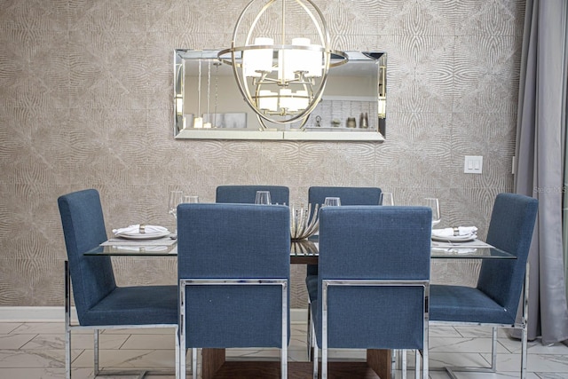 dining room with a chandelier, marble finish floor, baseboards, and wallpapered walls