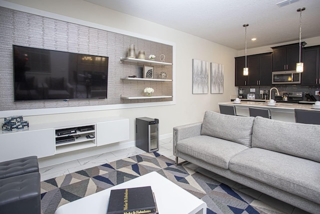 living area featuring visible vents and recessed lighting