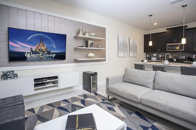 living area featuring light tile patterned floors and recessed lighting