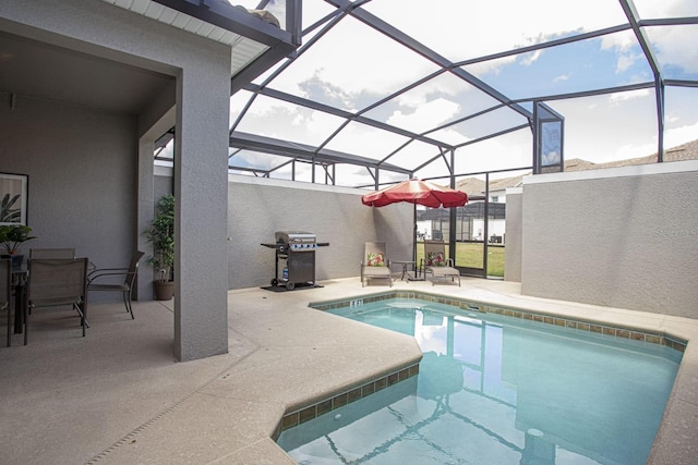 outdoor pool featuring a patio, area for grilling, and a lanai