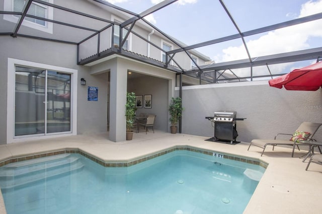 pool featuring glass enclosure, a patio, and a grill