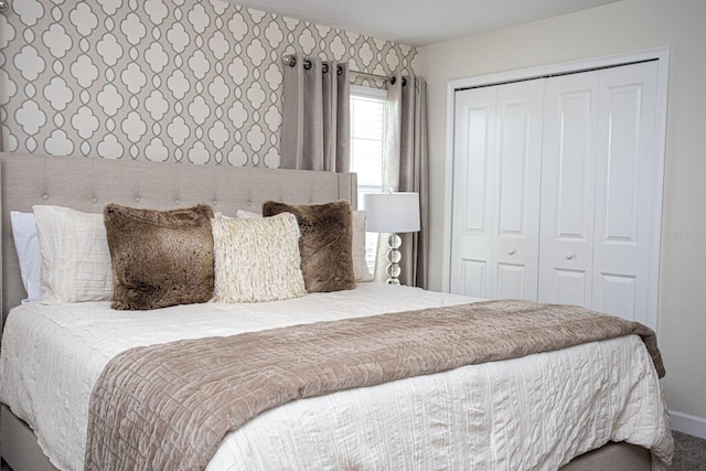 bedroom featuring wallpapered walls and a closet