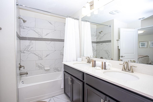 full bathroom with marble finish floor, visible vents, shower / bath combination with curtain, and a sink