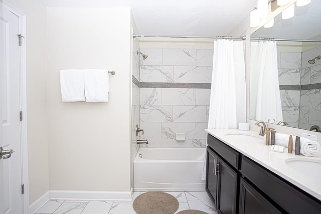 full bathroom with marble finish floor, shower / tub combo with curtain, double vanity, a sink, and baseboards