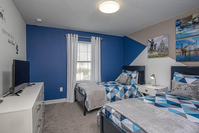 bedroom with a textured ceiling, baseboards, and light colored carpet