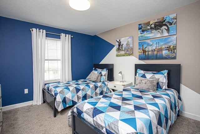 bedroom with a textured ceiling, carpet, and baseboards