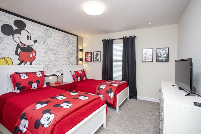 bedroom with carpet, baseboards, and a textured ceiling