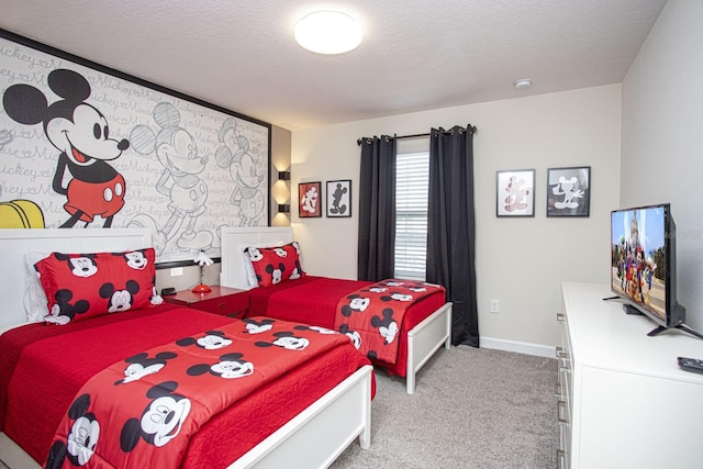 carpeted bedroom featuring baseboards and a textured ceiling