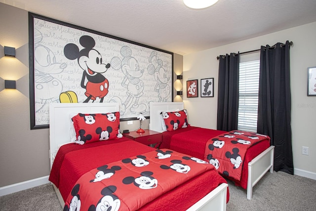 bedroom with a textured ceiling, carpet, and baseboards