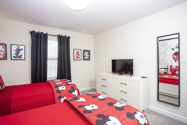 bedroom with light carpet, a textured ceiling, and baseboards