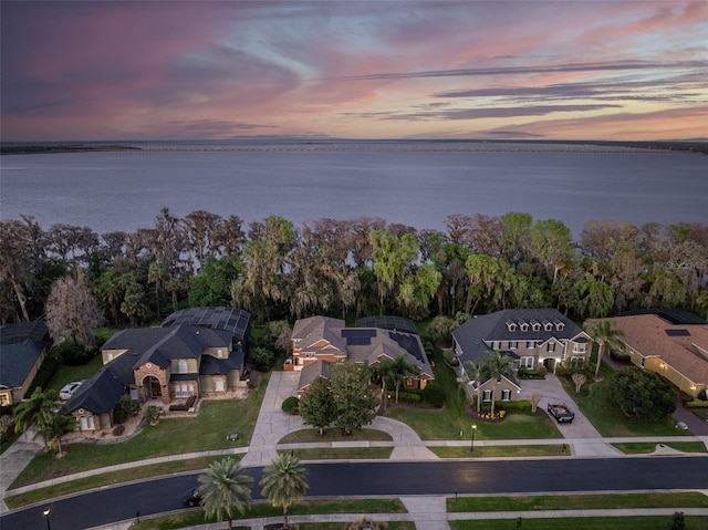 drone / aerial view with a residential view and a water view