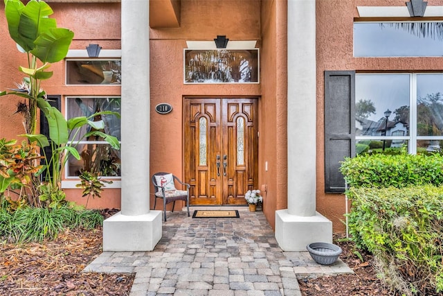 view of exterior entry with stucco siding