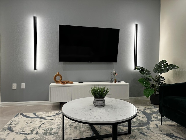 tiled living room featuring baseboards