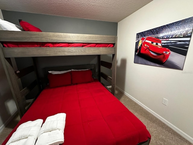 bedroom featuring carpet floors, a textured ceiling, and baseboards