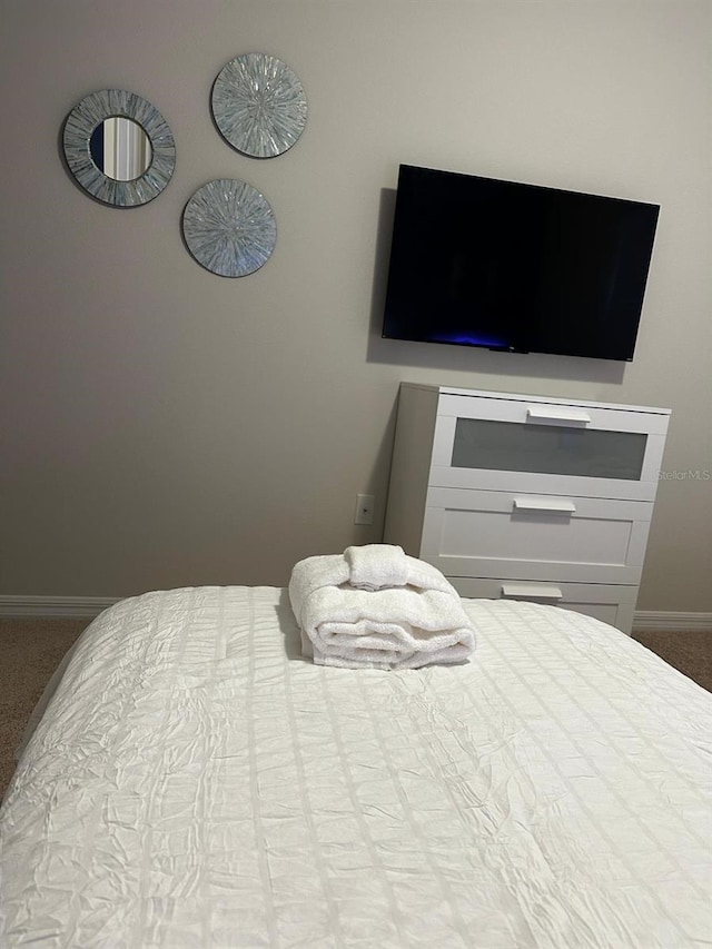 carpeted bedroom featuring baseboards