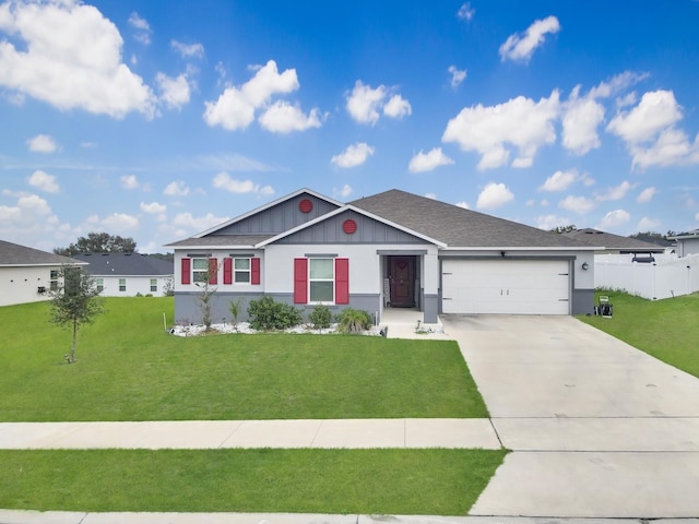 ranch-style house with a garage, a shingled roof, concrete driveway, a front lawn, and board and batten siding