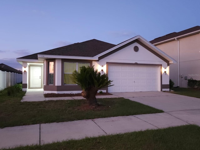 ranch-style house featuring stucco siding, concrete driveway, an attached garage, fence, and a front lawn