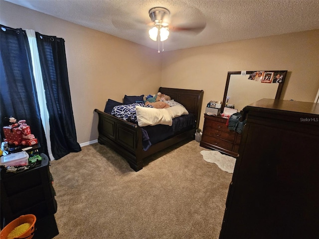 bedroom featuring light carpet, ceiling fan, a textured ceiling, and baseboards