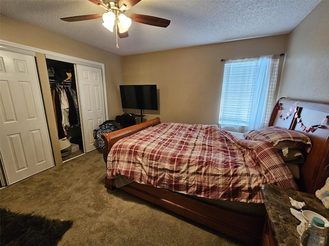 carpeted bedroom with ceiling fan, a closet, and a textured ceiling