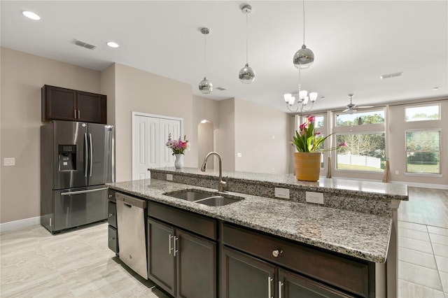 kitchen with a center island with sink, visible vents, stainless steel appliances, and a sink